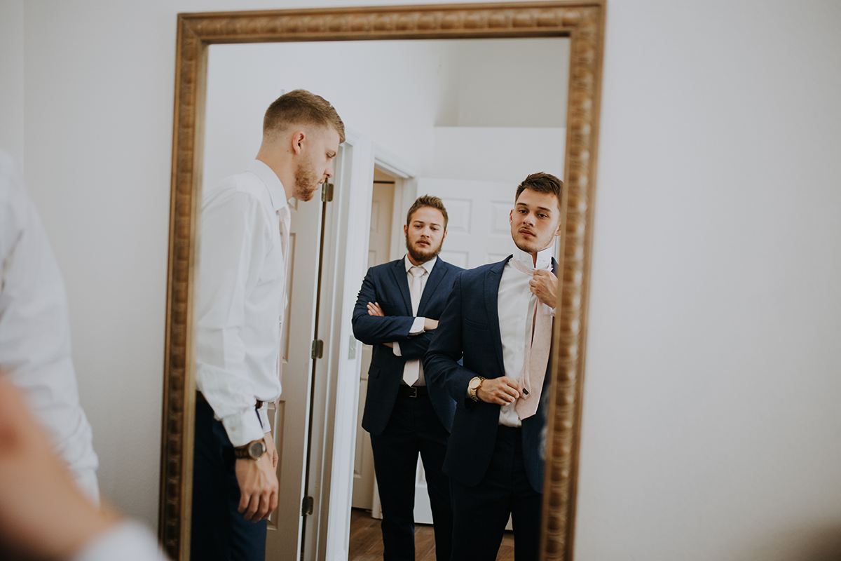 groom getting ready | straightening the tie | Florida wedding photographer